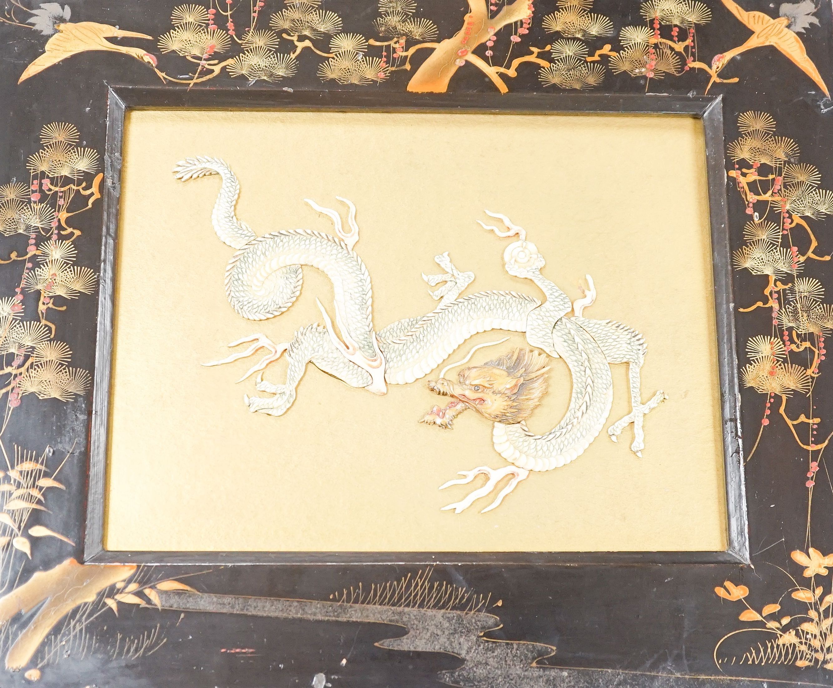 A Japanese bone ‘dragon’ and lacquer framed panel, early 20th century, 31 x 37 cm